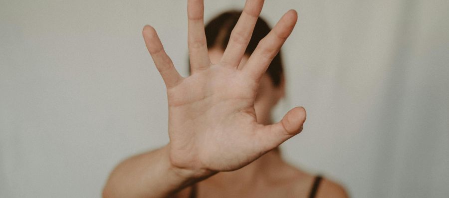 Frau, die eine Stopp-Gestik mit der Hand zeigt.